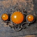 Vintage filigree brooch with baltic amber stone