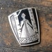 Vintage metal brooch. Woman in Russian national dress