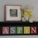Children Decor - Nursery Wall Decor 24" Black Shelf and 5 Wooden Letter Plaques in Pink, Gray, Green, Yellow and Red - ASPYN