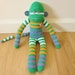 Carrot juice sock monkey plush doll - green, orange, white, and purple stripes