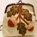 Elegant Acorn Bough wool felt purse with metal frame.