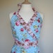 Retro apron Sweetie, vintage floral fusion pattern on blue fabric. 1950s inspired, fully lined.