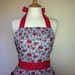 Retro apron, vintage inspired pink floral pattern on blue apron, fully lined.