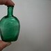 tiny little vintage horse shoe shaped spearmint green bottle . assemblage bottles . tiny bottle