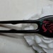 Hair fork Tribal Rose made with Gaboon Ebony over Babinga wood inlayed with Red Howlite and Green Malachite