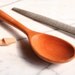 Wooden spoon for stirring with tasting spoon carved onto the handle