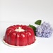 Red bundt cake pan and portable holder