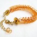Braided bracelet in orange and gold, Chevron motif