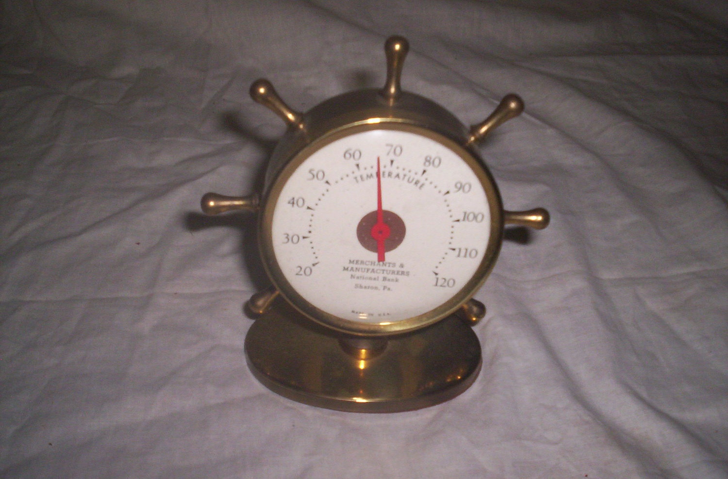 vintage brass advertising thermometer