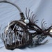 Scrap metal angler fish sculpture with working light