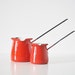 Pair of Red Enamel Pitchers