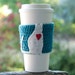 Coffee Cozy, crocheted, white cat, red heart, turquoise sleeve