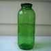 Vintage green glass juice/water bottle with black metal lid