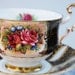 Paragon Tea Cup and Saucer, Black and Gold with Roses