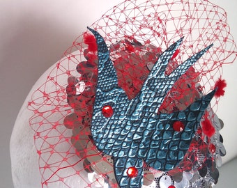 silver sequined fascinator with red tule and blue swallow