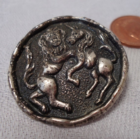 Vintage button the lion and the unicorn metal embossed.