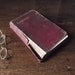decaying leather bound Longfellow poetry book