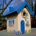 Blue Birdhouse with Spring Flowers
