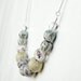 Pastel blue, yellow, and lilac beaded necklace, fabric and paper covered beads