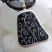White swirls on ebony sea pottery necklace - black ribbon and cord - hand painted