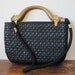 vintage black woven purse with wooden handles and long strap