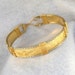 wire wrapped bangle bracelet. 14K gold filled pattern Sterling silver accents.