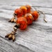 orange and antique brass bee charm earrings, orange beaded earrings, handmade earrings,