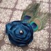 handmade teal satin flower with sea green pearl center and peacock feathers on headband or hair clip