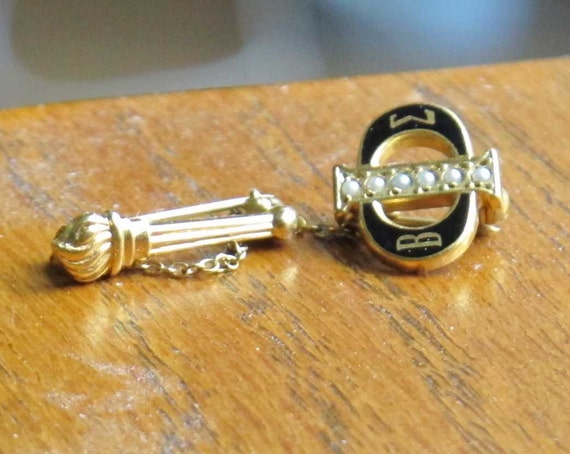 Beta Sigma Phi pin in gold tones with torch and chain