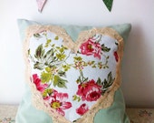 Sage green and pink floral cushion with vintage lace trim.