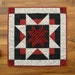 Quilted Table Topper in Red, White and Black Star