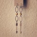 adela. a pair of golden arrow earrings.