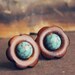 elfin. a pair of woodsy floral marbled teal cab earrings.