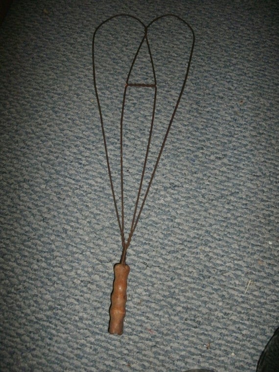 Vintage rug beater metal with wooden handle