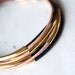 Black and Beige Leather Bracelet with 6 Golden tubes by pardes israel