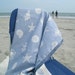 One of a kind throw with soft blue and off white shells, fish, and sea life featured.