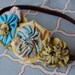 Six fabric yoyos on elastic headband