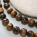 10mm . Tigers Eye round beads . 27 beads
