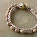 Earth tone Seed Bracelet, brown wax cord and brass bell