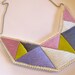Bib necklace embroidered geometric triangles in beautiful light colors and dramatic design Spring fashion