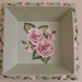 Hand painted bouquet of pink roses framed with pink rosebuds on soft green background