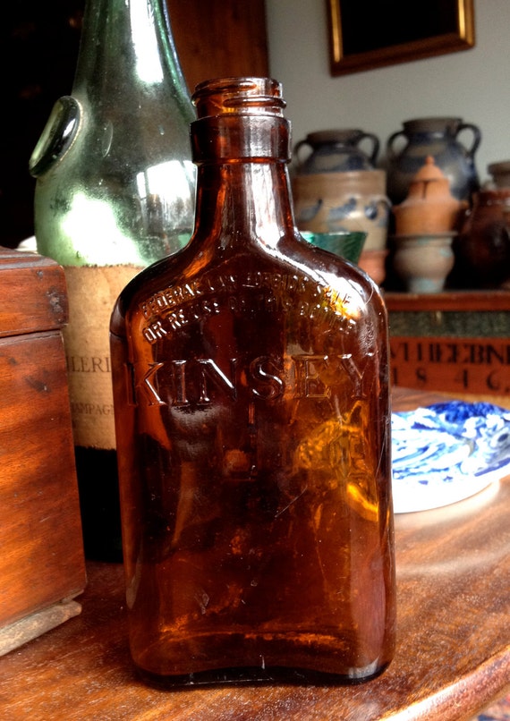 Vintage Glass Liquor Bottle Flask In An Amber Brown Color