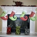 Whimsical red and green personalized Christmas stocking with curly elf toe