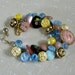 Vintage button bracelet glass, metal and plastic buttons in pink, yellow, blue and black hearts and flowers