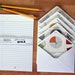 Made from a math book. Set of five die cut lined envelopes, 10 sheets custom lined paper, custom seals.