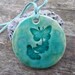 Butterfly pendant, mint green crackle glaze, blushes of pink, seafoam suede