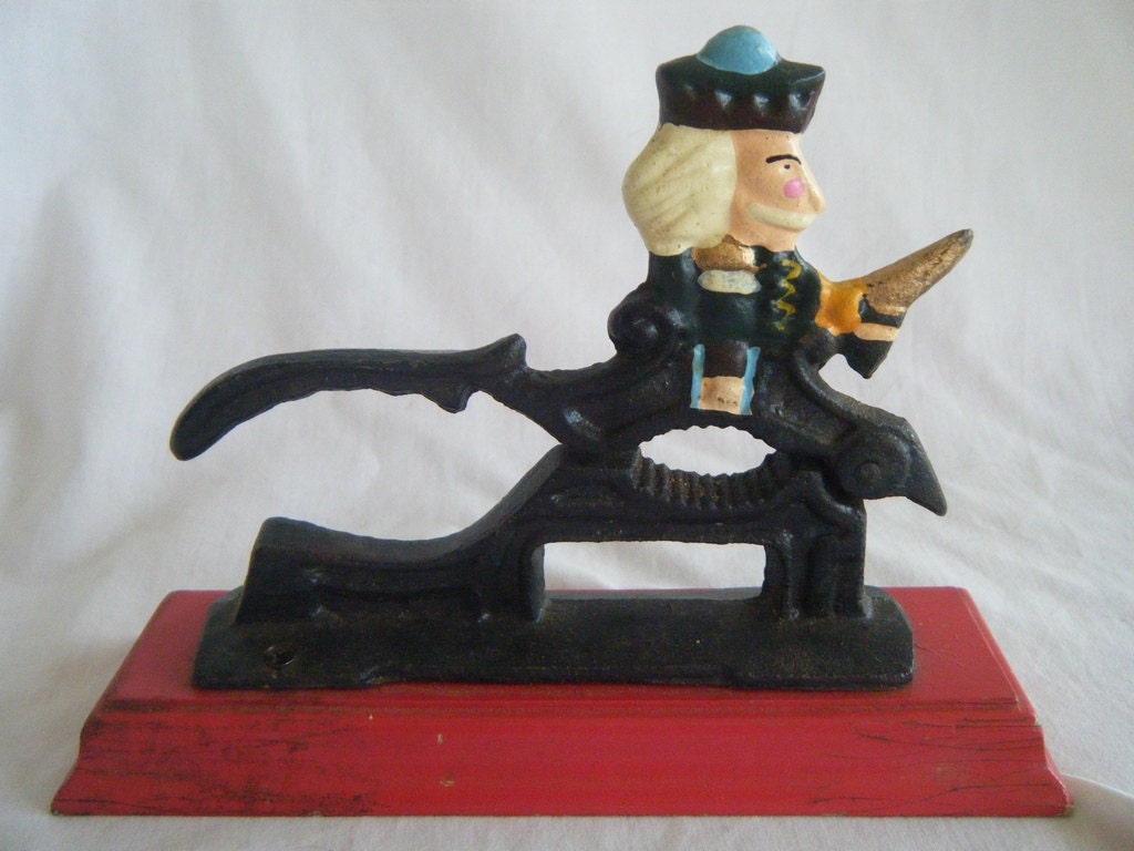 Nutcracker Cast Iron on wooden base by VintageAnything on Etsy