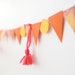pretty in coral, pink, orange, yellow garland with tassels
