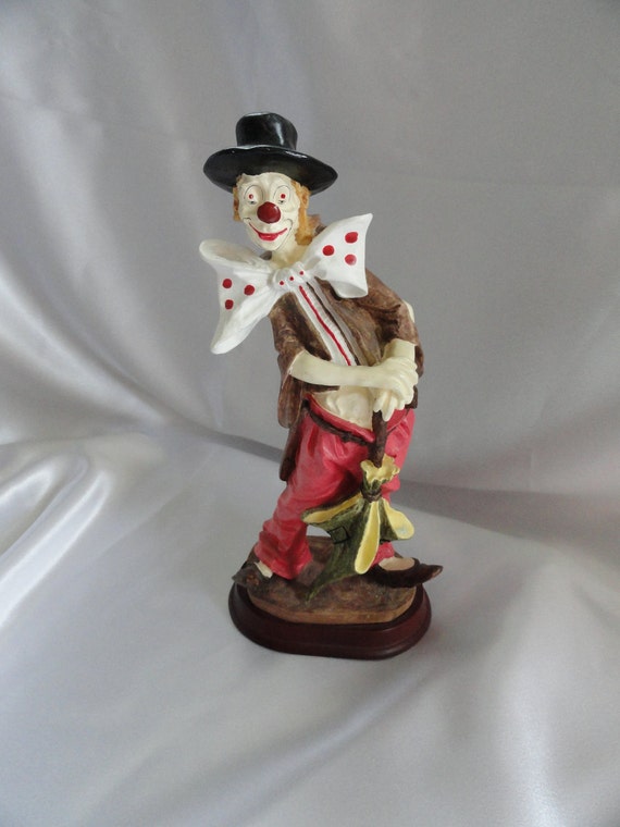 Resin clown figurine on wooden base features hobo look with
