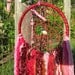 Dreamcatcher Wall Hanging - Cherry Ripe colors butterfly and bead in web with yarn hanging down, beads and crystal drop